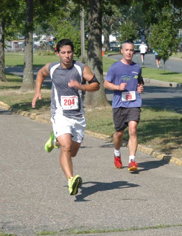 Norwalk's Samuel Valencia, left, sprints to the finish of the 15th Annual Ian James Eaccarino Memorial -Mile Race. 